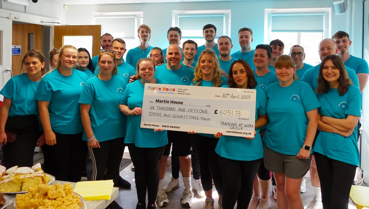 TAWG team with cheque Cycle to the Serengeti Challenge - Completed